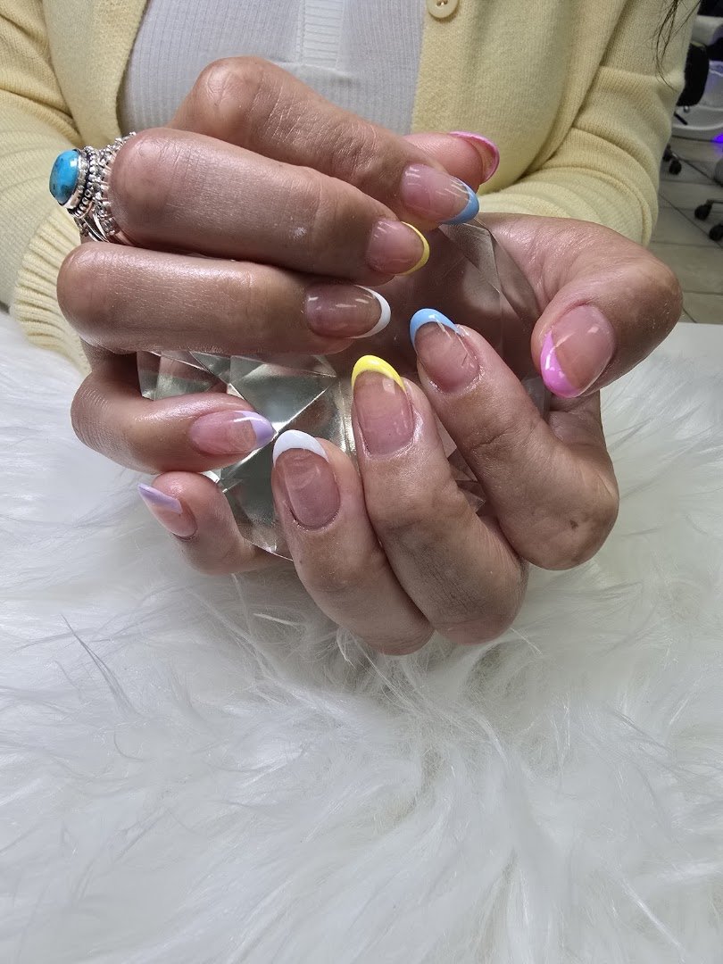 Manicured hands beside a bright color display.
